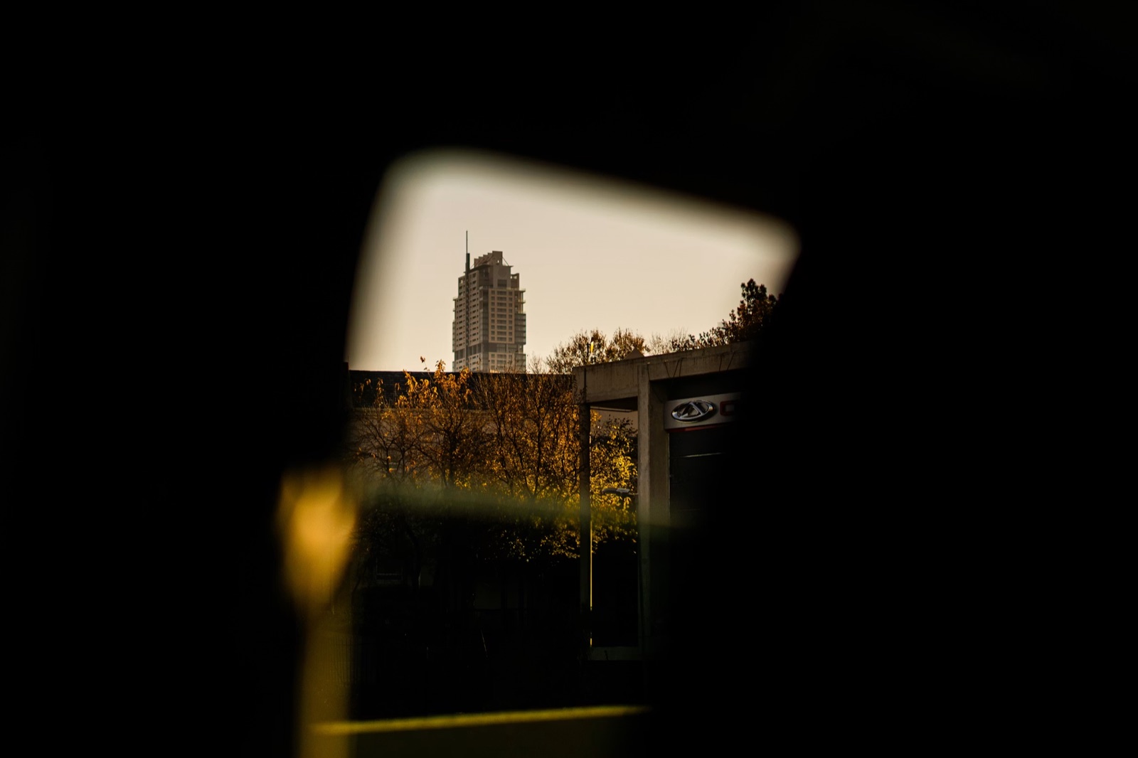The Ponte tower on the Johannesburg skyline, framed through a car window at dusk